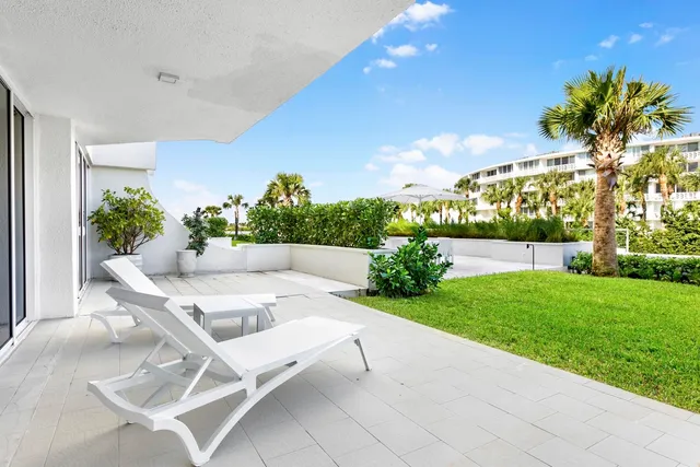 a patio with a patio table and chairs