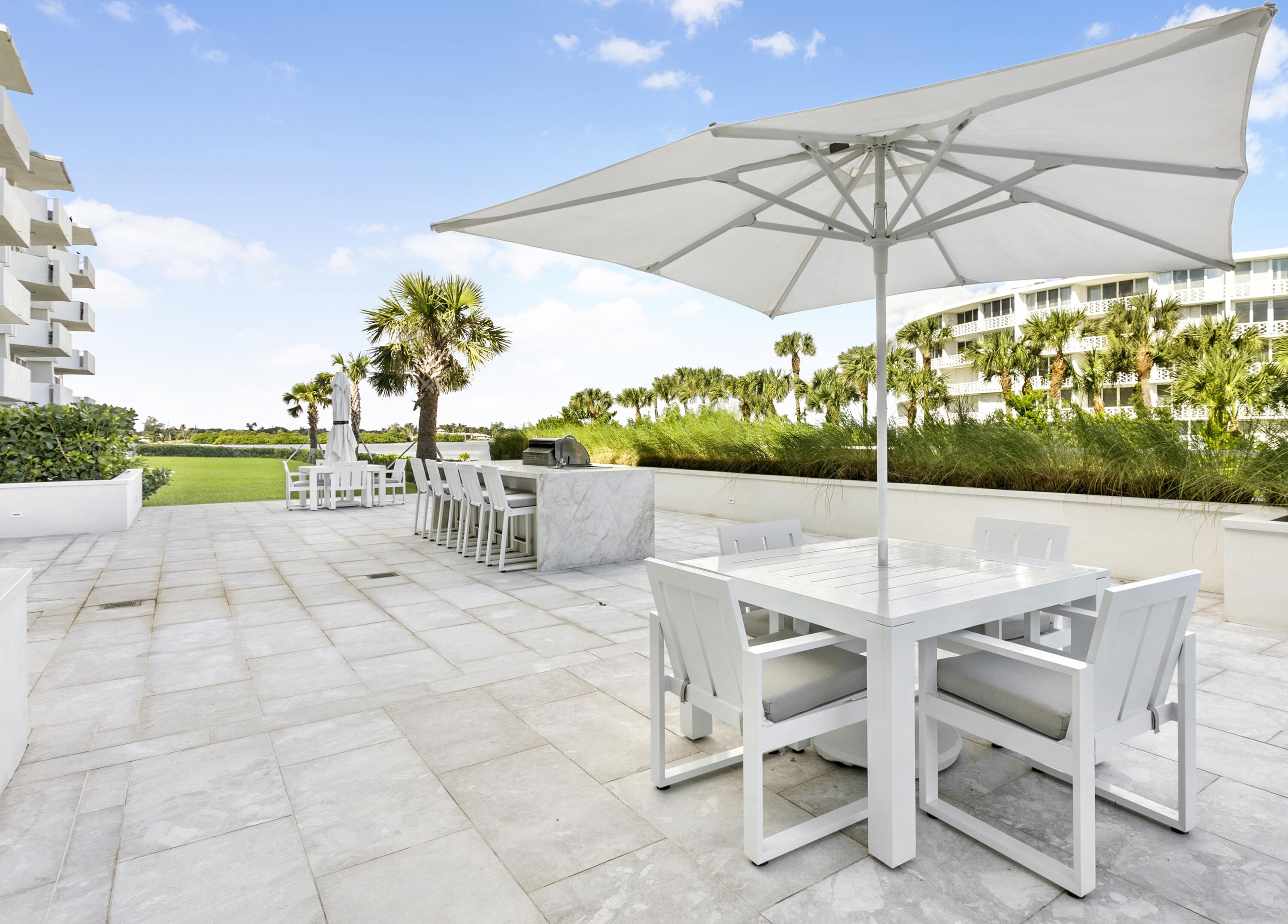 2773 South Ocean Boulevard, Unit 109 Palm Beach, FL 33480 - Photo 23 of 36 a patio with a patio table and chairs