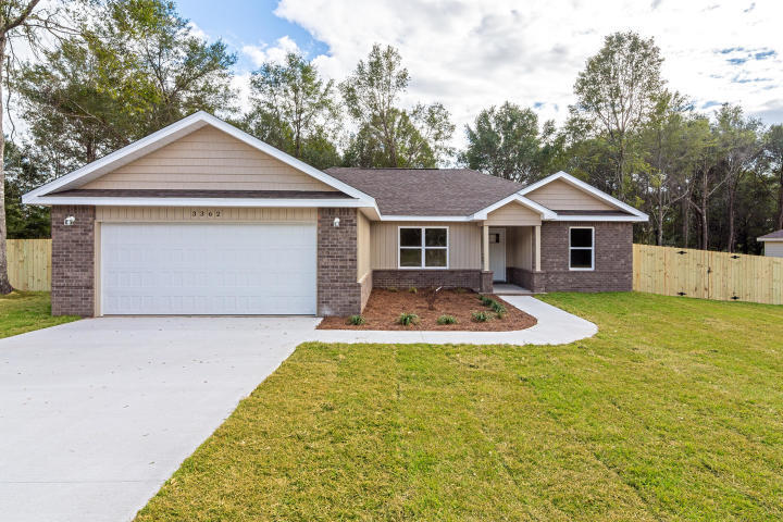 961 Valley Road Crestview, FL 32539 - Photo 1 of 3 a front view of a house with yard and green space
