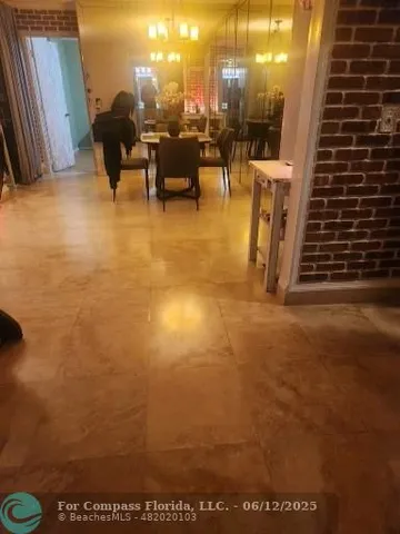 a view of a room with a small white door and a window