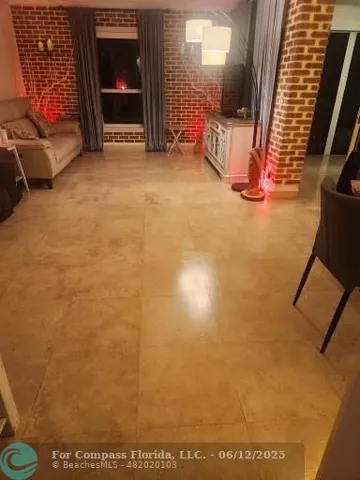 a view of a patio with dining table and chairs with wooden floor