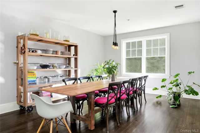 a dining room with furniture window and wooden floor