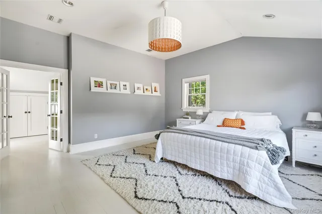 a bedroom with bed and a window