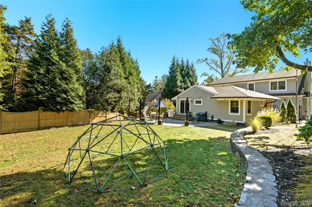 a view of a house with pool and sitting area