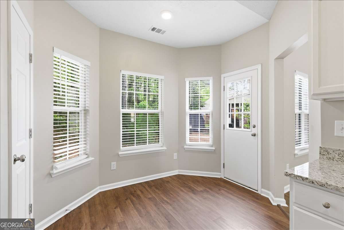 4634 Noah Valley Acworth, GA 30101 - Photo 11 of 27 a view of an empty room with wooden floor and a window