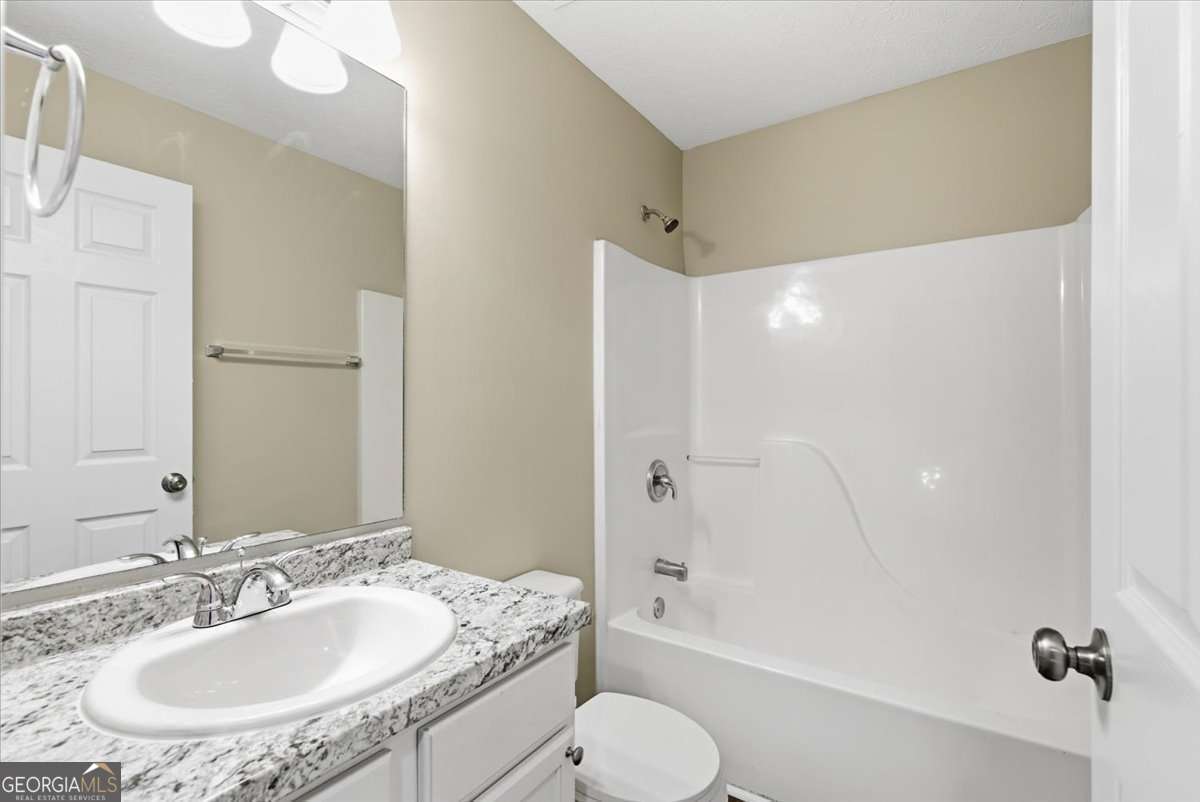 4634 Noah Valley Acworth, GA 30101 - Photo 12 of 27 a bathroom with a granite countertop sink toilet and shower