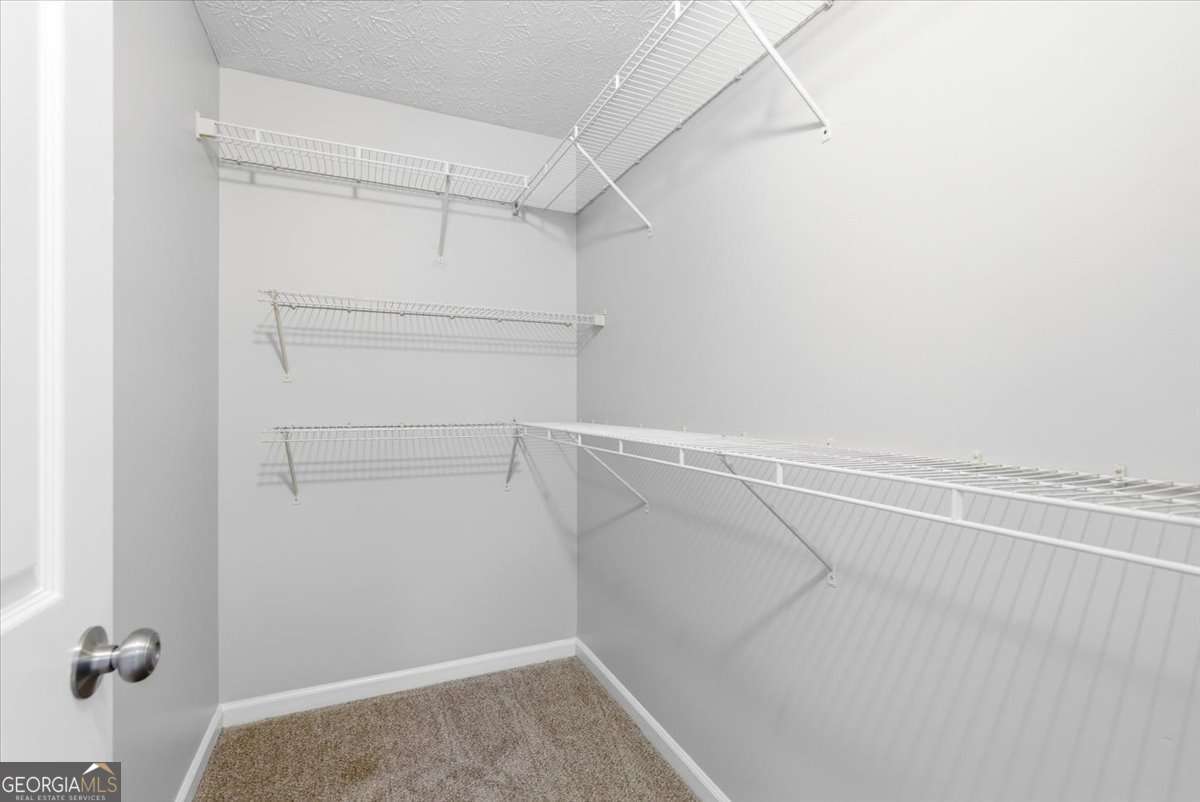 4634 Noah Valley Acworth, GA 30101 - Photo 16 of 27 a view of a room with racks on the wall