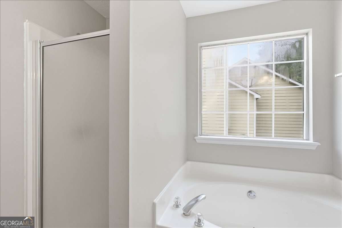 4634 Noah Valley Acworth, GA 30101 - Photo 17 of 27 a bathroom with a bathtub and a shower