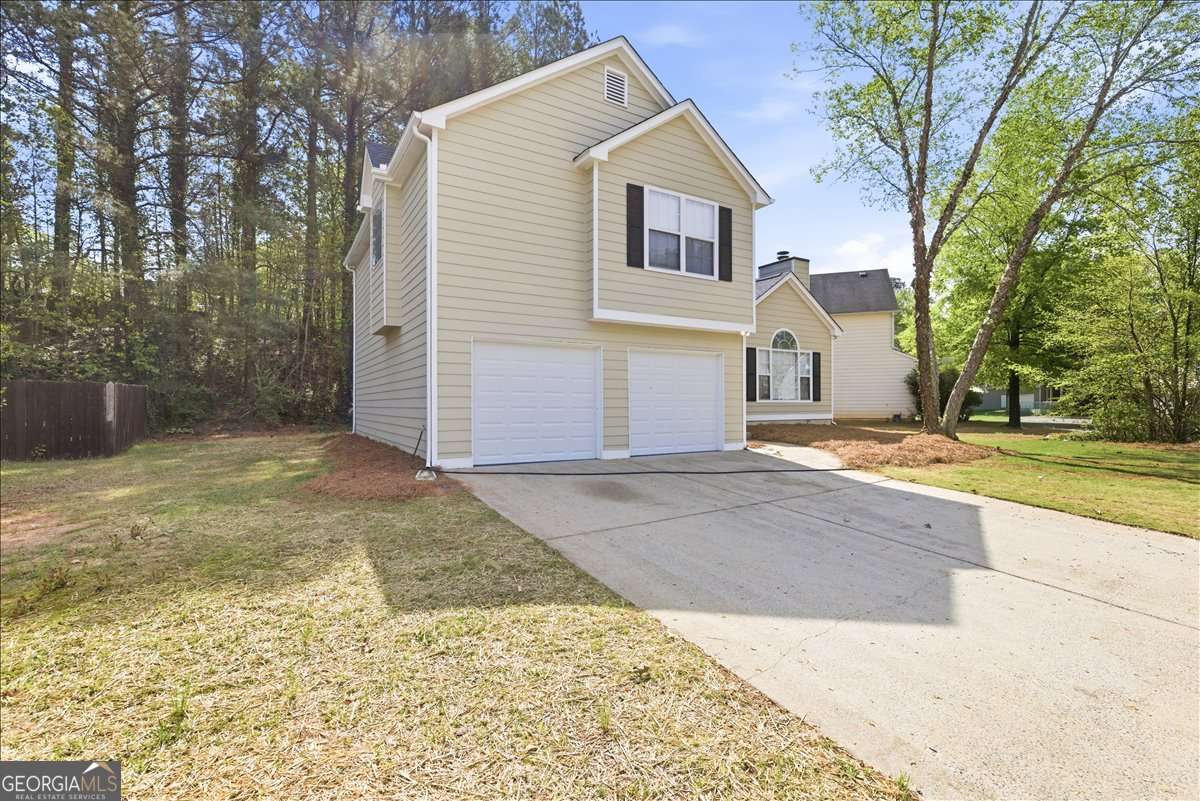 4634 Noah Valley Acworth, GA 30101 - Photo 3 of 27 a view of a white house with a large tree