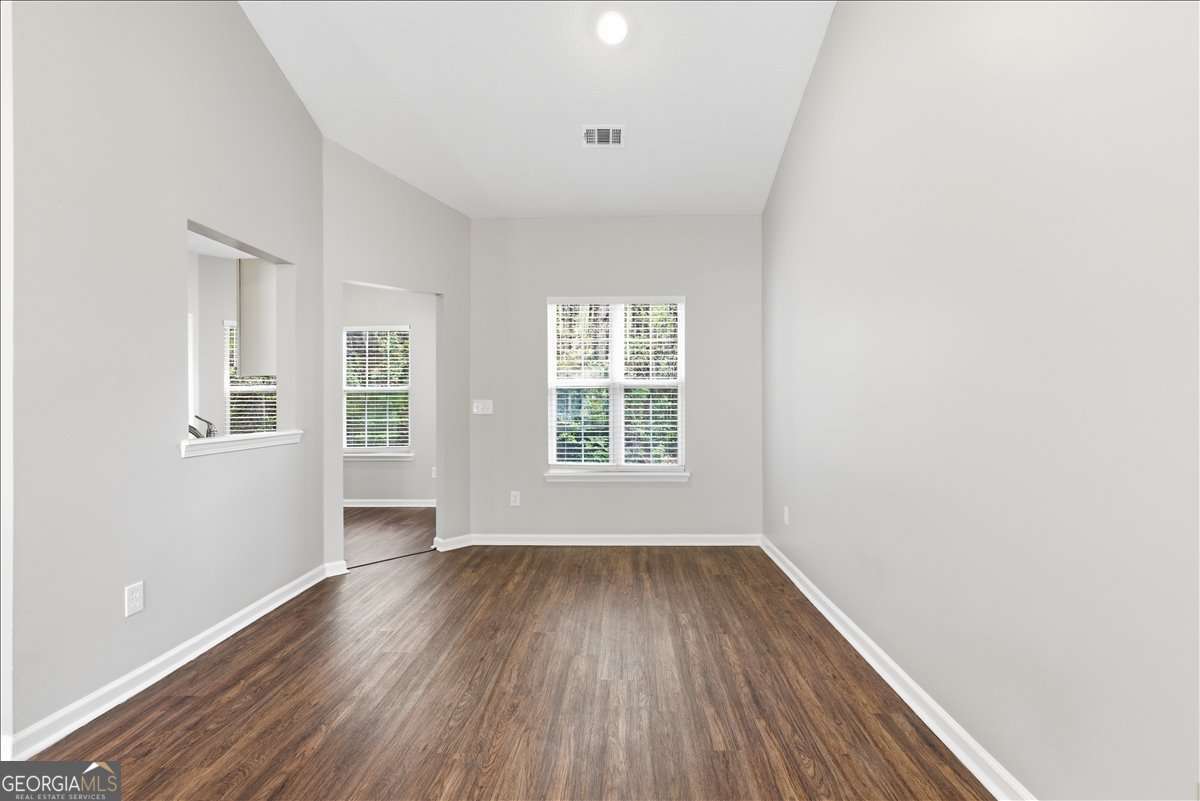4634 Noah Valley Acworth, GA 30101 - Photo 7 of 27 a view of an empty room with wooden floor and a window
