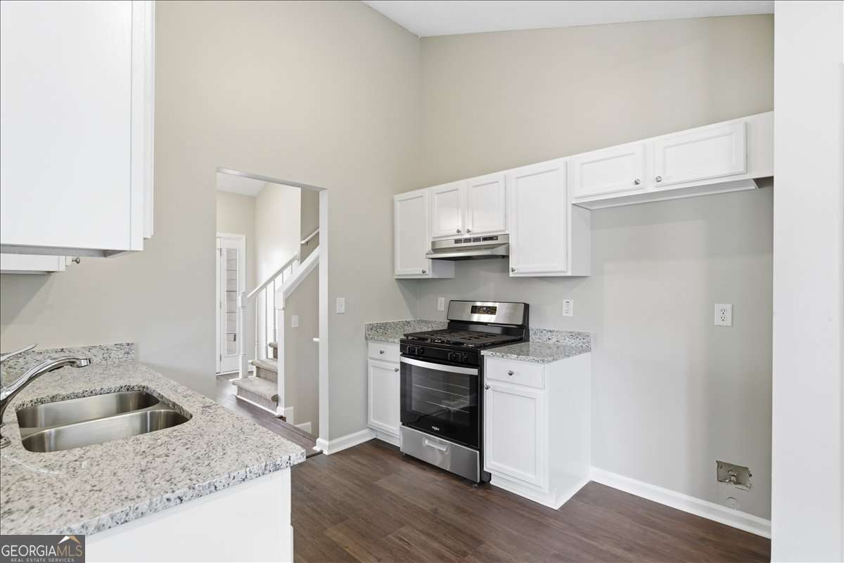 4634 Noah Valley Acworth, GA 30101 - Photo 10 of 27 a kitchen with stainless steel appliances granite countertop a sink stove and refrigerator