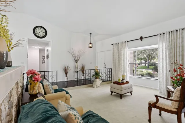 a kitchen with stainless steel appliances granite countertop a refrigerator a oven a sink a dining table and chairs with wooden floor