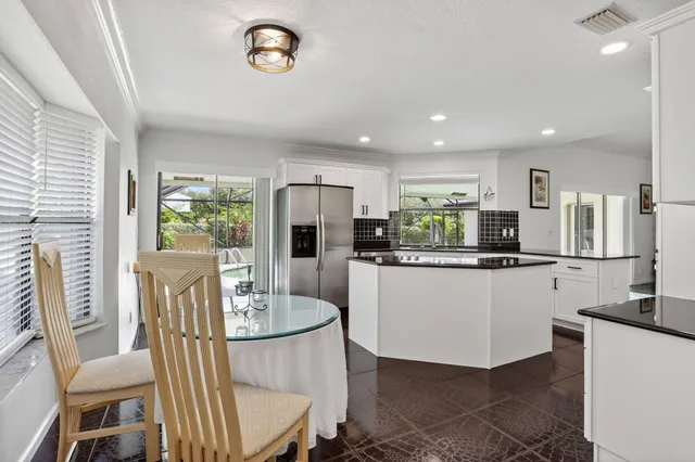 a living room with furniture and a view of kitchen