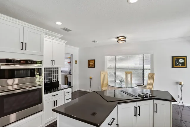 a view of a workspace with furniture and wooden floor