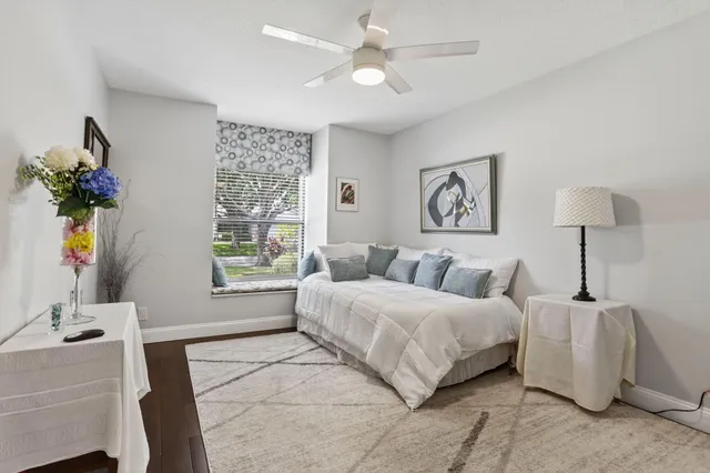 a spacious bedroom with a bed and a chandelier