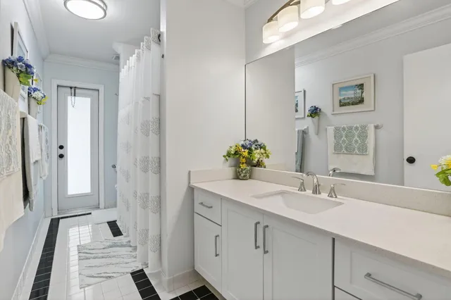 an aerial view of residential houses with outdoor space and trees
