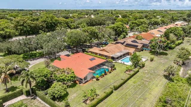 a front view of house with a garden and trees
