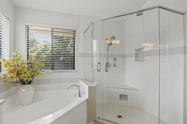 an aerial view of residential houses with outdoor space and trees