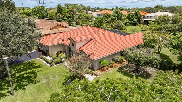 an aerial view of a residential houses with outdoor space and street view