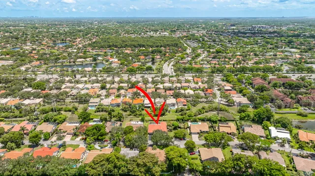 a green field with trees in the background