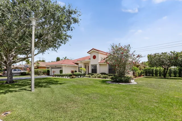 a view of backyard of house with green space