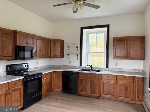 a kitchen with a sink stove top oven and microwave