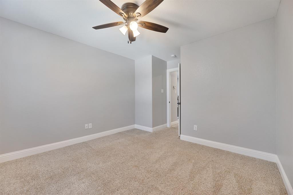 1713 Bronco Road Granbury, TX 76049 - Photo 20 of 23 Neutral gray walls with white baseboards and textured carpeting