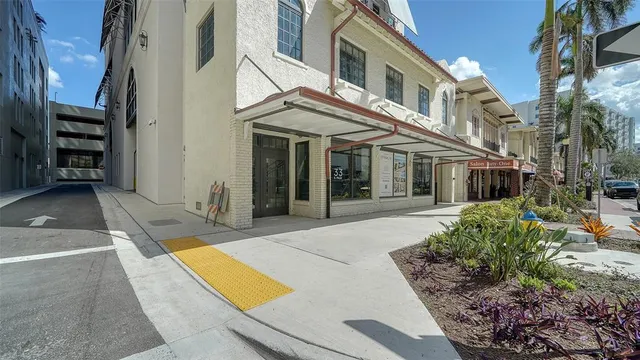 a view of a white house with many windows and yard