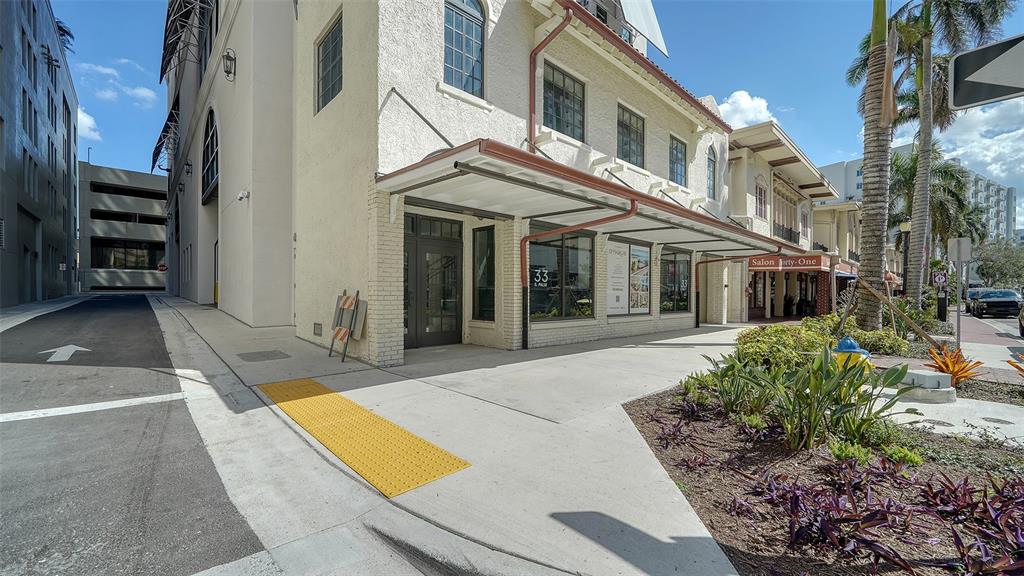 33 South Palm Avenue, Unit 804 Sarasota, FL 34236 - Photo 2 of 42 a view of a white house with many windows and yard