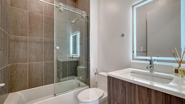 a bathroom with a sink toilet and shower