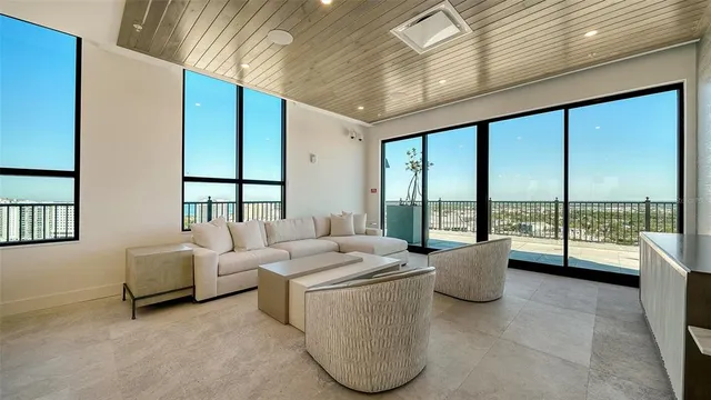 a living room with furniture and a floor to ceiling window
