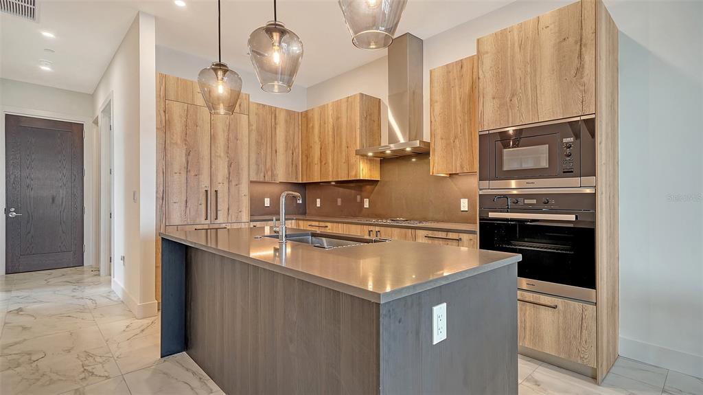 33 South Palm Avenue, Unit 804 Sarasota, FL 34236 - Photo 7 of 42 a kitchen with stainless steel appliances granite countertop a sink a stove and a refrigerator