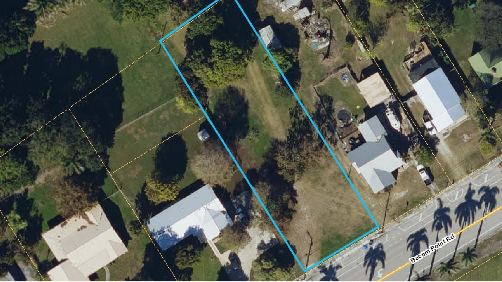 1697 Bacom Point Road Pahokee, FL 33476 - Photo 2 of 7 an aerial view of a residential apartment building with a yard