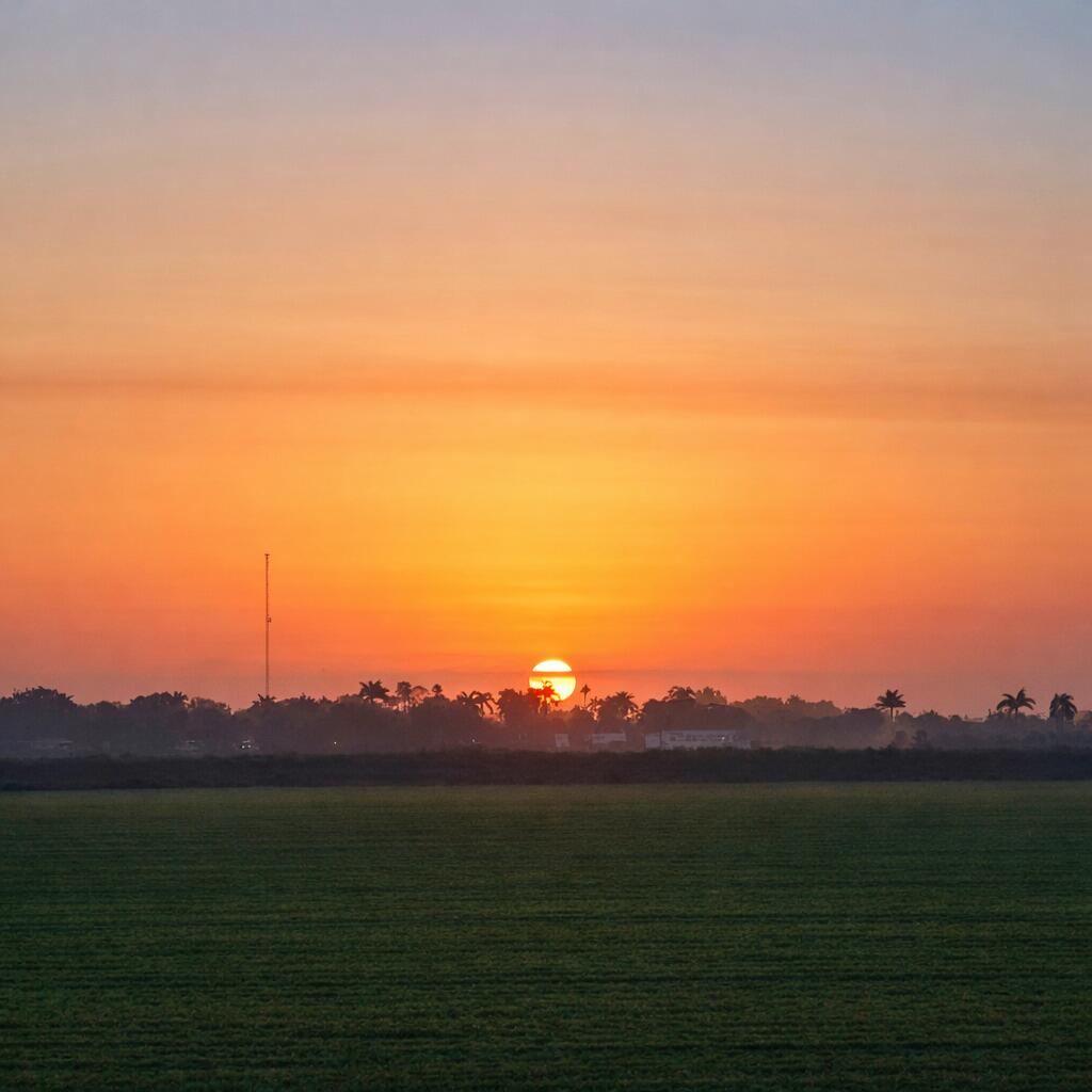1697 Bacom Point Road Pahokee, FL 33476 - Photo 7 of 7 a view of a lake with sunset