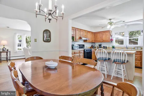 a dining room with furniture a chandelier and window