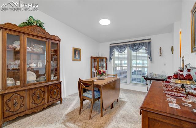 12825 Garrett Road Peyton, CO 80831 - Photo 16 of 47 Dining space featuring light colored carpet and lofted ceiling