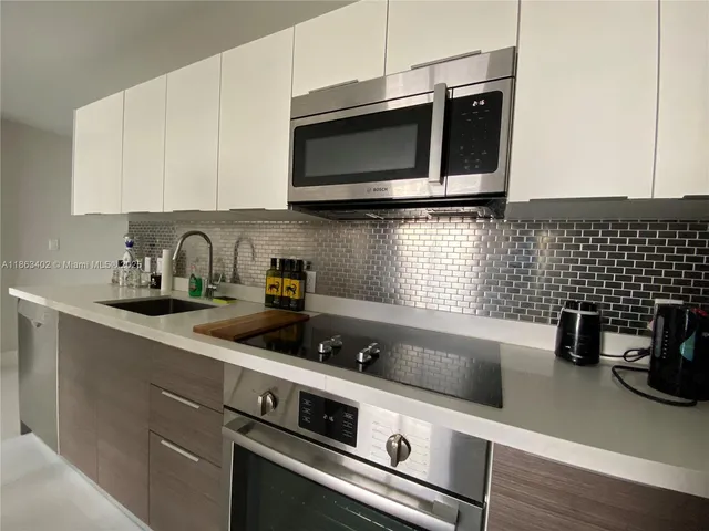 a kitchen with a sink and cabinets