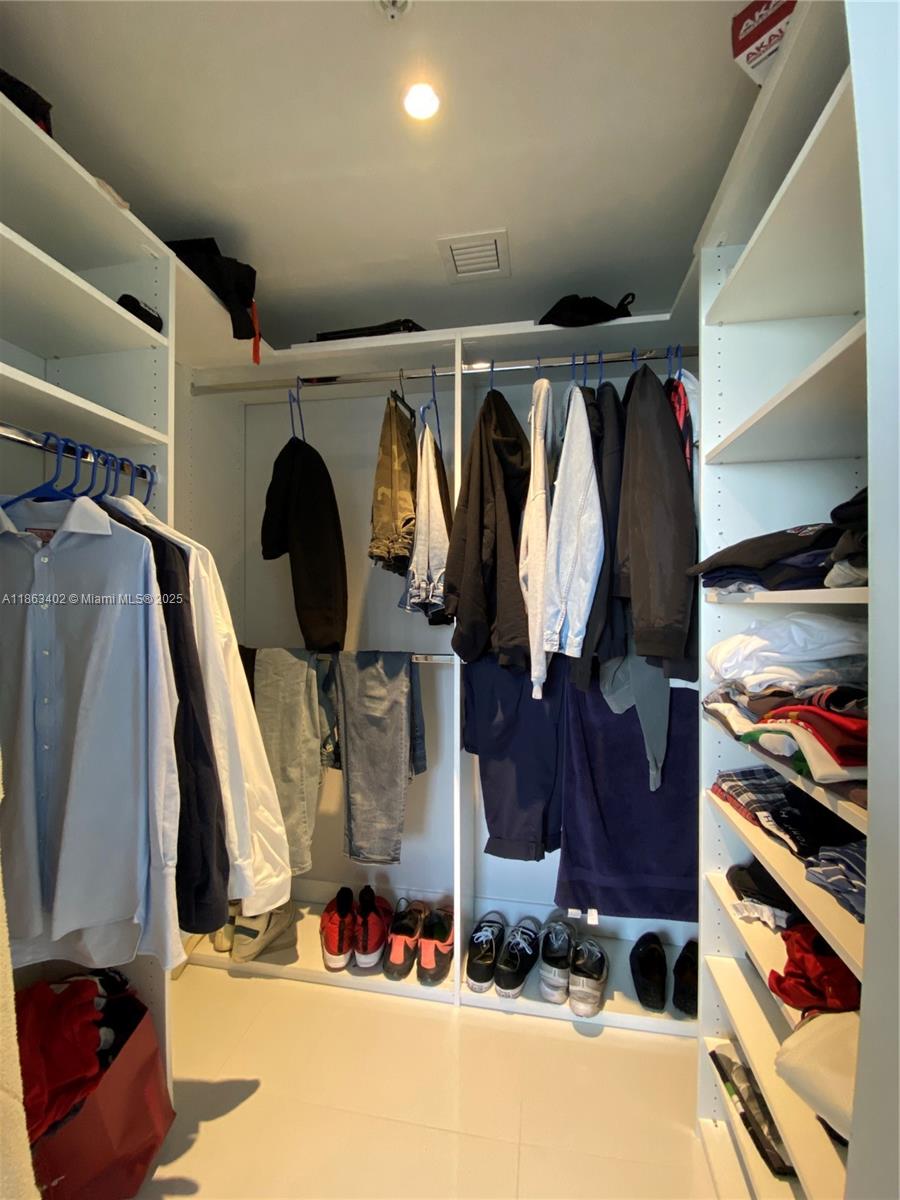 1010 Southwest 2nd Avenue, Unit 1110 Miami, FL 33130 - Photo 13 of 18 a view of walk in closet with clothes and shoes