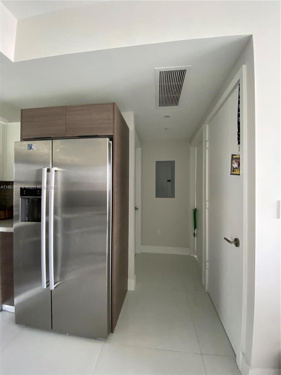 1010 Southwest 2nd Avenue, Unit 1110 Miami, FL 33130 - Photo 14 of 18 a view of a refrigerator in kitchen and a kitchen