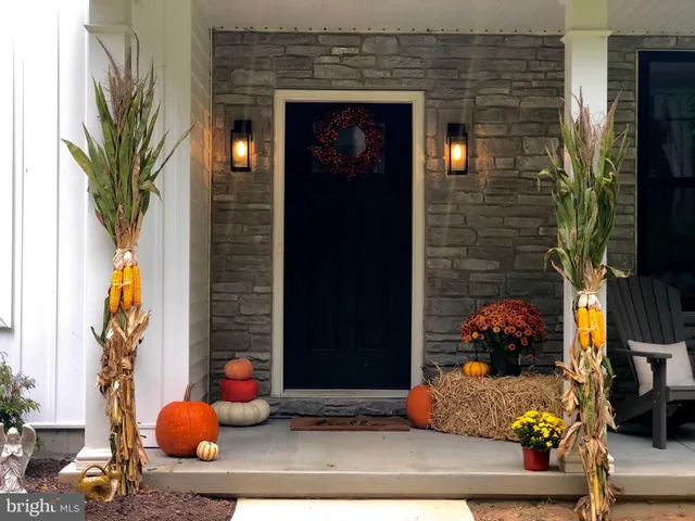 a room with painting on the wall and a potted plant