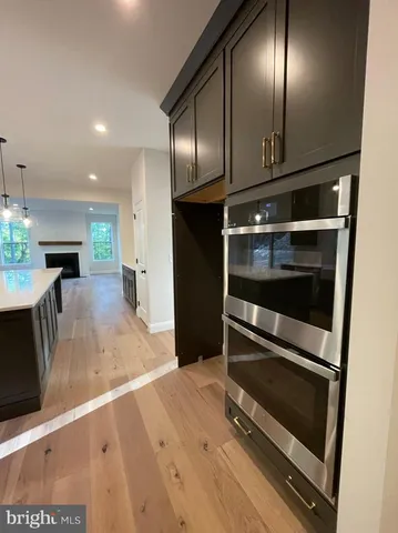 a view of a living room with stainless steel appliances wooden floor and floors
