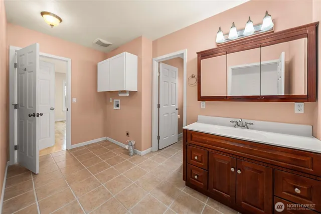 a spacious bathroom with a double vanity sink a mirror and a shower