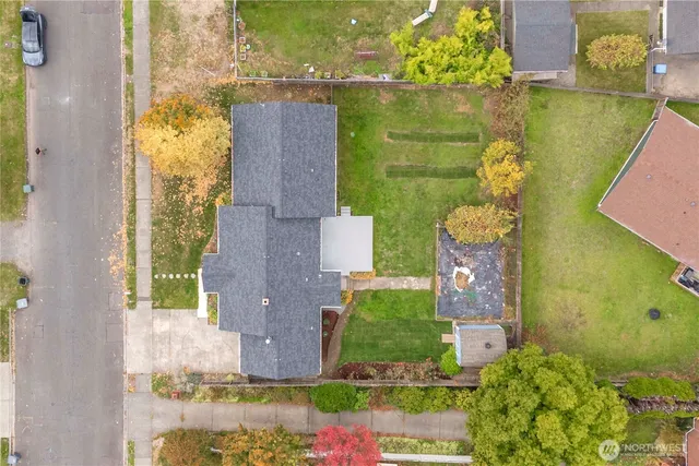 an aerial view of a house with a yard