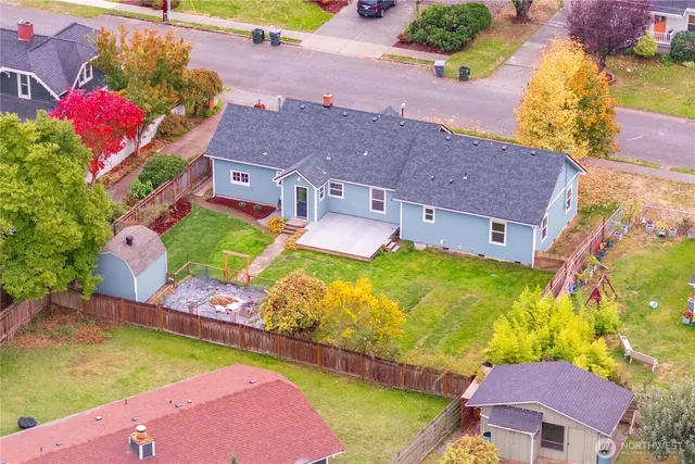 an aerial view of a house with a swimming pool yard and outdoor seating