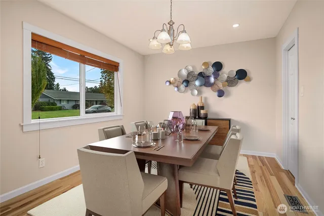 a view of a dining room with furniture wooden floor and a chandelier