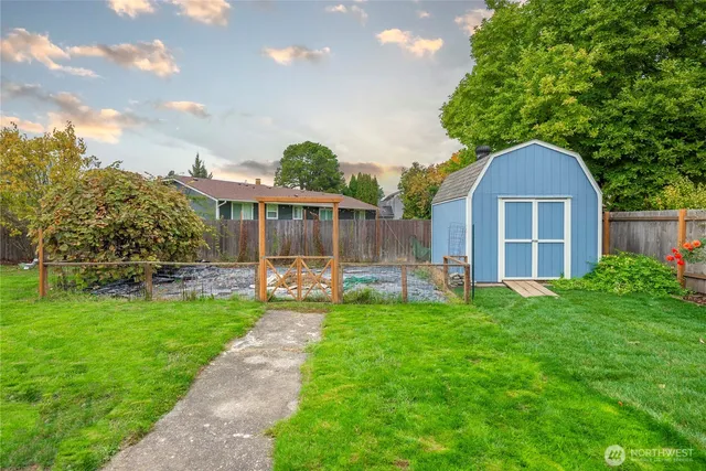 a view of a house with a backyard and a patio