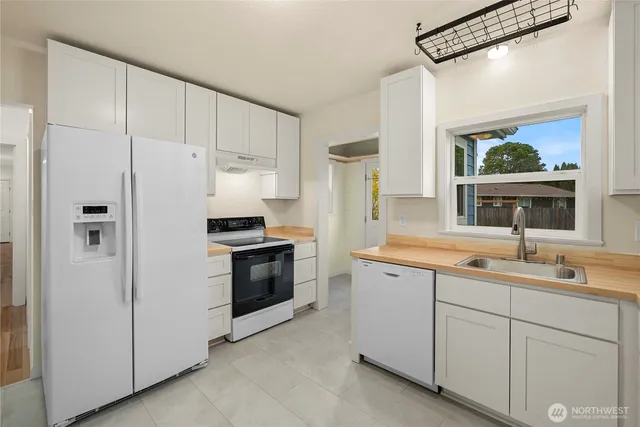 a kitchen with a sink appliances and cabinets