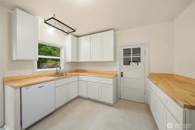 a kitchen with a sink window and cabinets