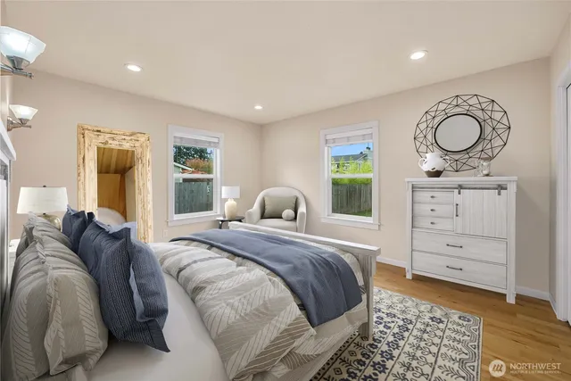 a bedroom with a bed and wooden floor