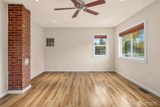 a view of a room with wooden floor and windows